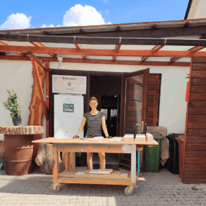 Melanie Wabro vor der Schreinerei in Weinheim am Werkstatttisch mit Holzbrettern